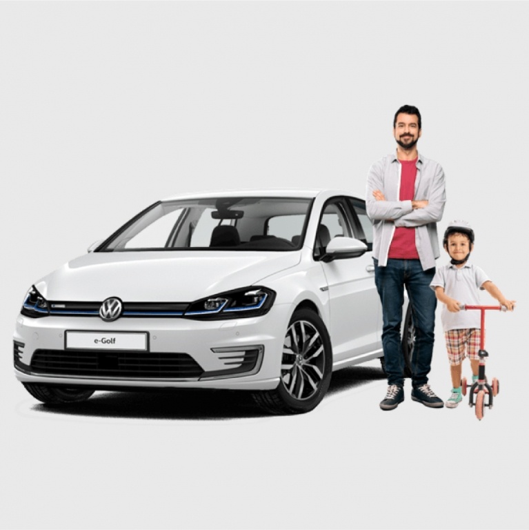 Father and son next to a VW e-Golf electric car
