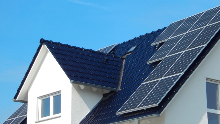 Ten black solar panels on roof of detached home 